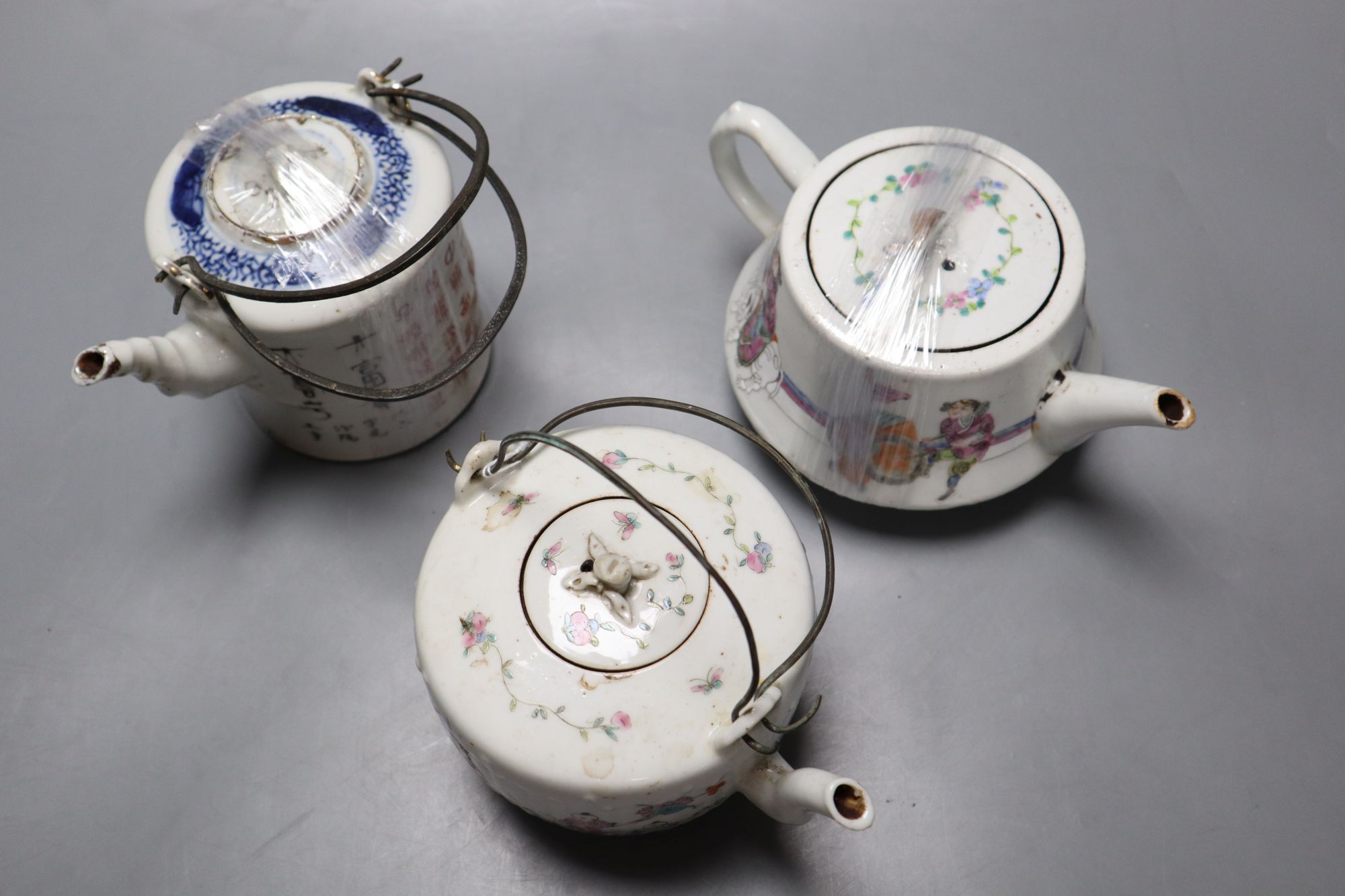 Two Chinese famille rose teapots and covers, and a calligraphic teapot, tallest 10cm